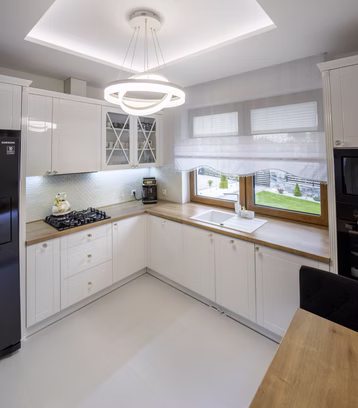 White fitted kitchen with a ring pendant light