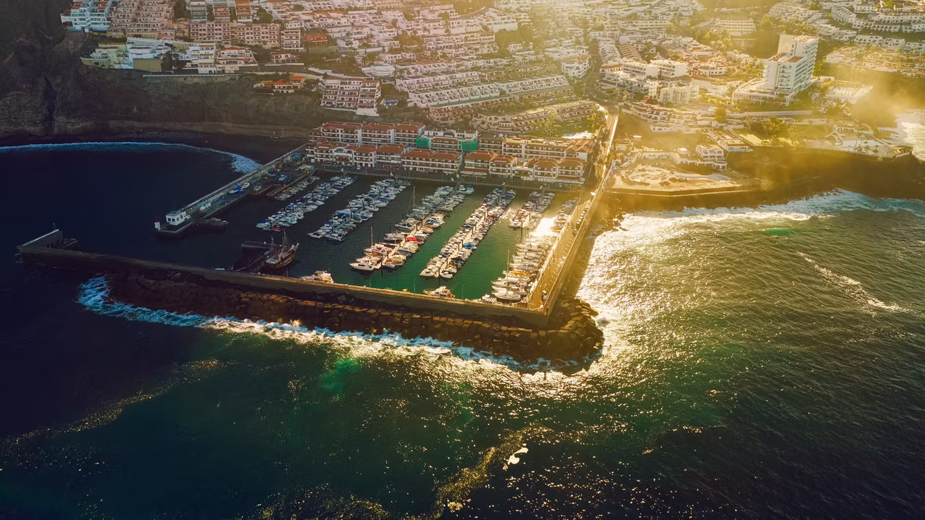 Rocky headland and marina glowing at sunset