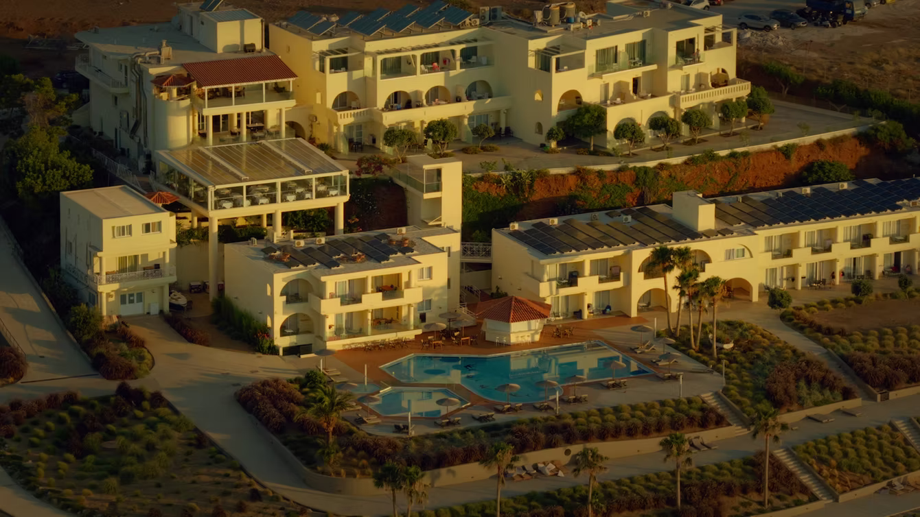 Terraced hotel with pools and gardens seen from the air